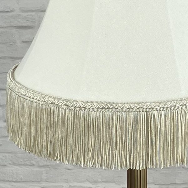 cream bowed empire lampshade with fringe switched off