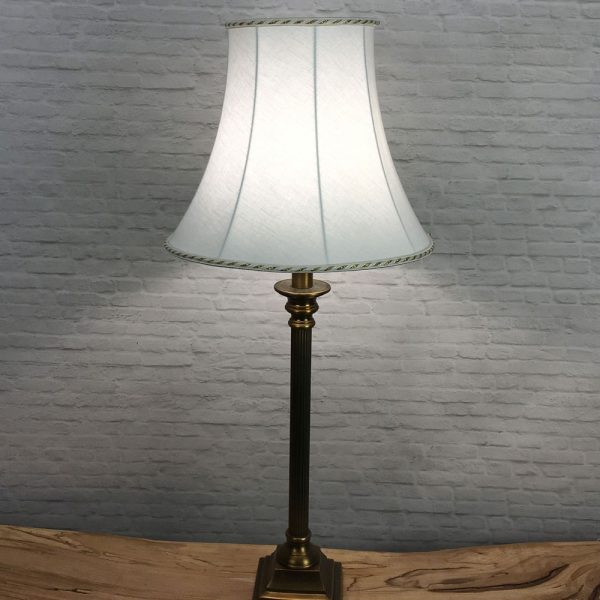 white and gold bowed empire table lampshade switched on