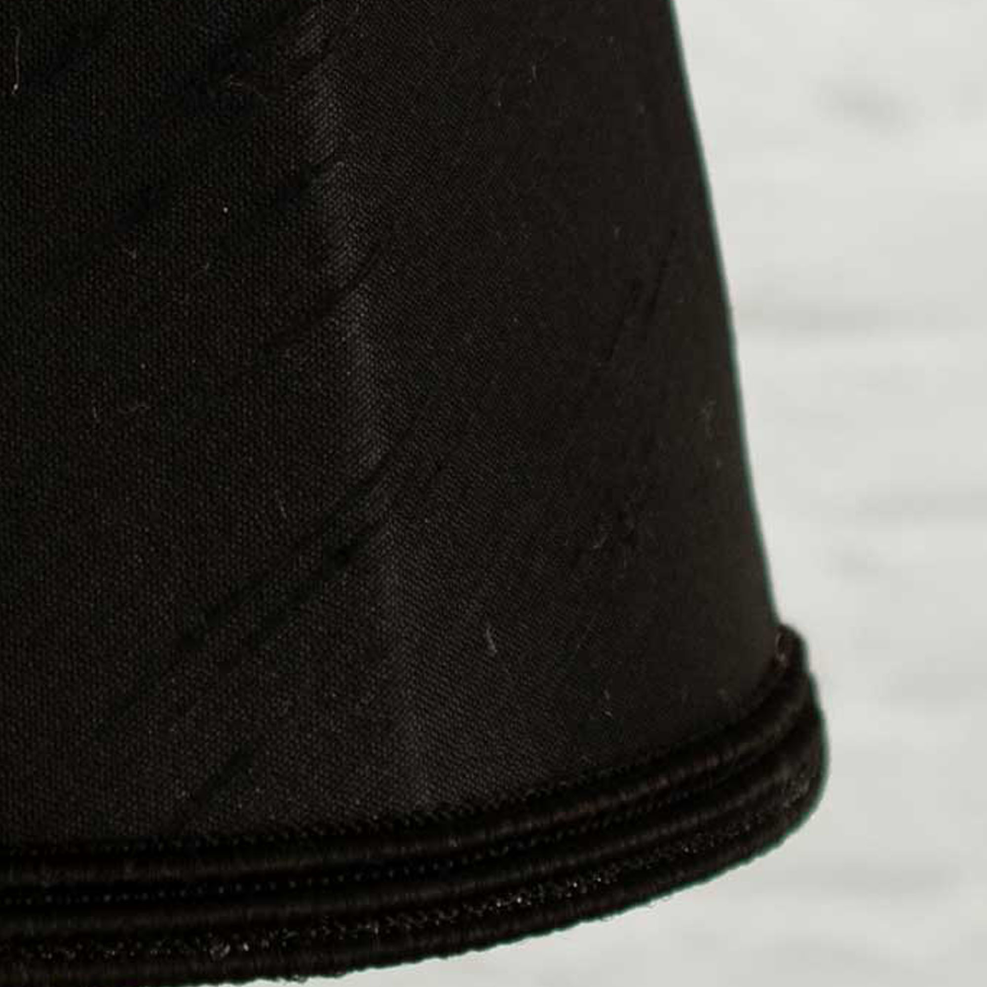 Close-up of black faux silk fabric showing dupion slub texture on empire chandelier shade