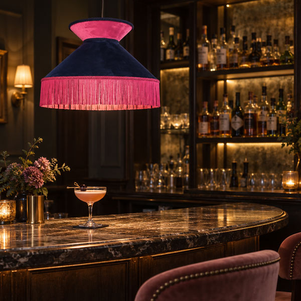Bar A moody cocktail bar with our statement blue velvet and hot pink lampshade