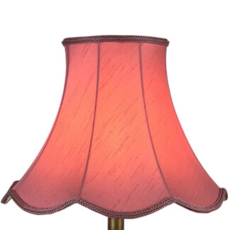 Illuminated pink bon bon faux silk scalloped lampshade with bon bon rope trim