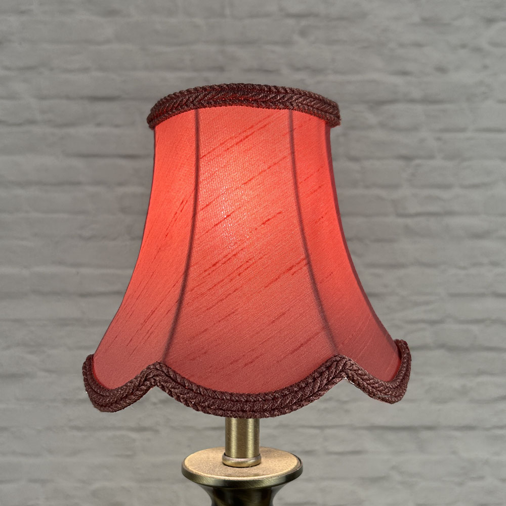 Bon bon scalloped chandelier shade in faux silk lit showing soft glow and plait trim