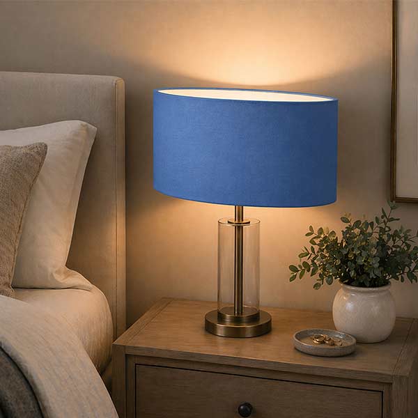 Handmade oval lampshade displayed on a stylish table lamp in a contemporary living room.