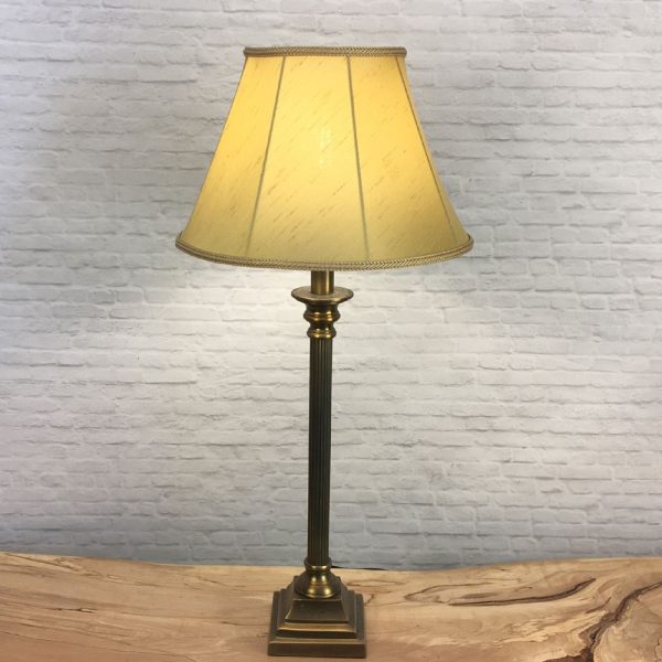 A Traditional table lamp showing our straight sided Empire lampshade in Old Gold faux silk with a matching Old Gold Rope Braid. Shown switched on. Suitable for all table, floor and standard lampshades