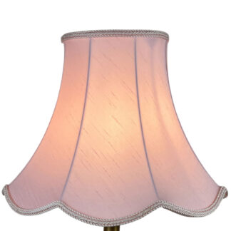Illuminated pale pink faux silk scalloped lampshade with pale pink rope trim