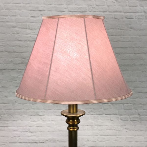 A Traditional table lamp showing our straight sided Empire lampshade in Dusty Rose Linen with a Rose Soutache trim top and bottom. Shown switched on. Suitable for all table, floor and standard lampshades