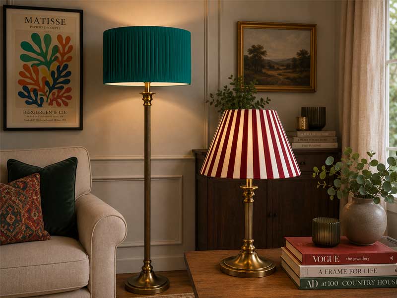 Green and red pleated lampshades on floor and table lamps