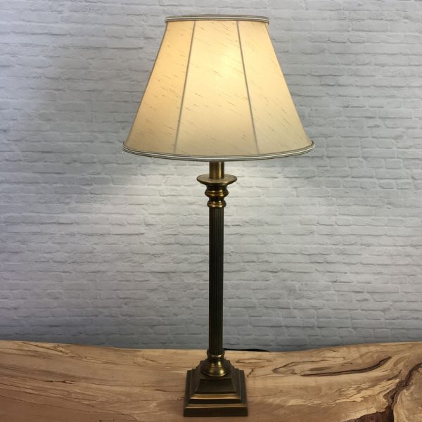 A Traditional table lamp showing our straight sided Empire lampshade in Fawn faux silk with a two toned fawn and oyster trim. Shown switched on. Suitable for all table, floor and standard lampshades