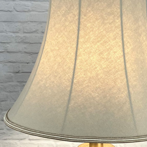 Close up image of the Fawn Brushed Cotton Bowed Empire Lampshade, showing the Two Tone Fawn and Oyster Soutache Trim, Lit Up