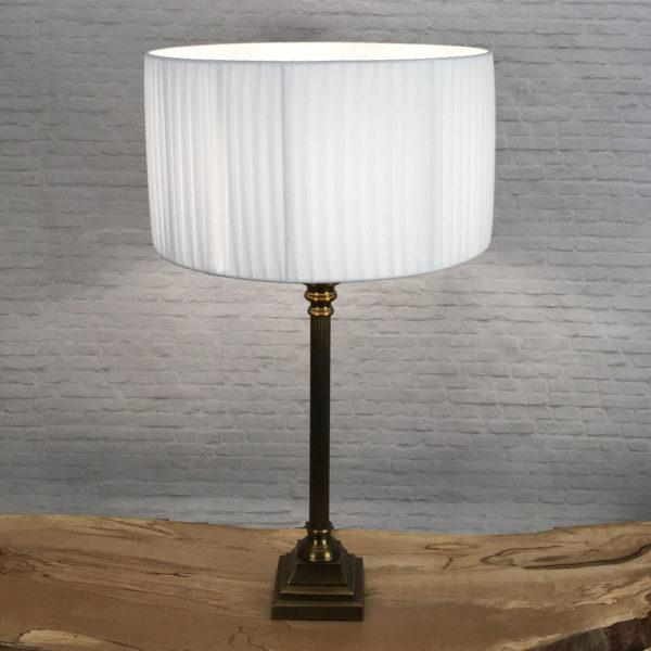 White pleated Drum lampshade shown on a table lamps