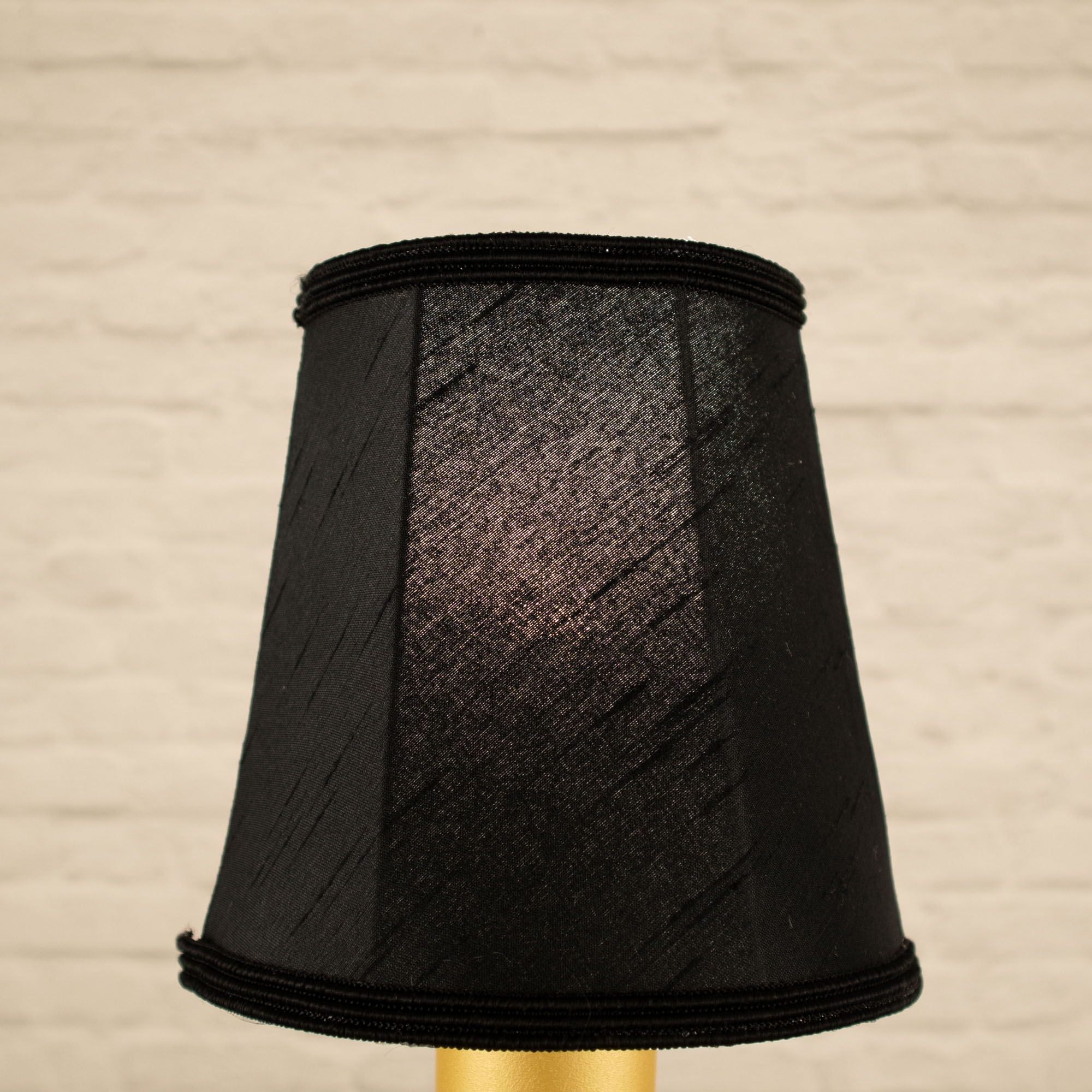 Lit black empire faux silk chandelier shade with matching soutache trim