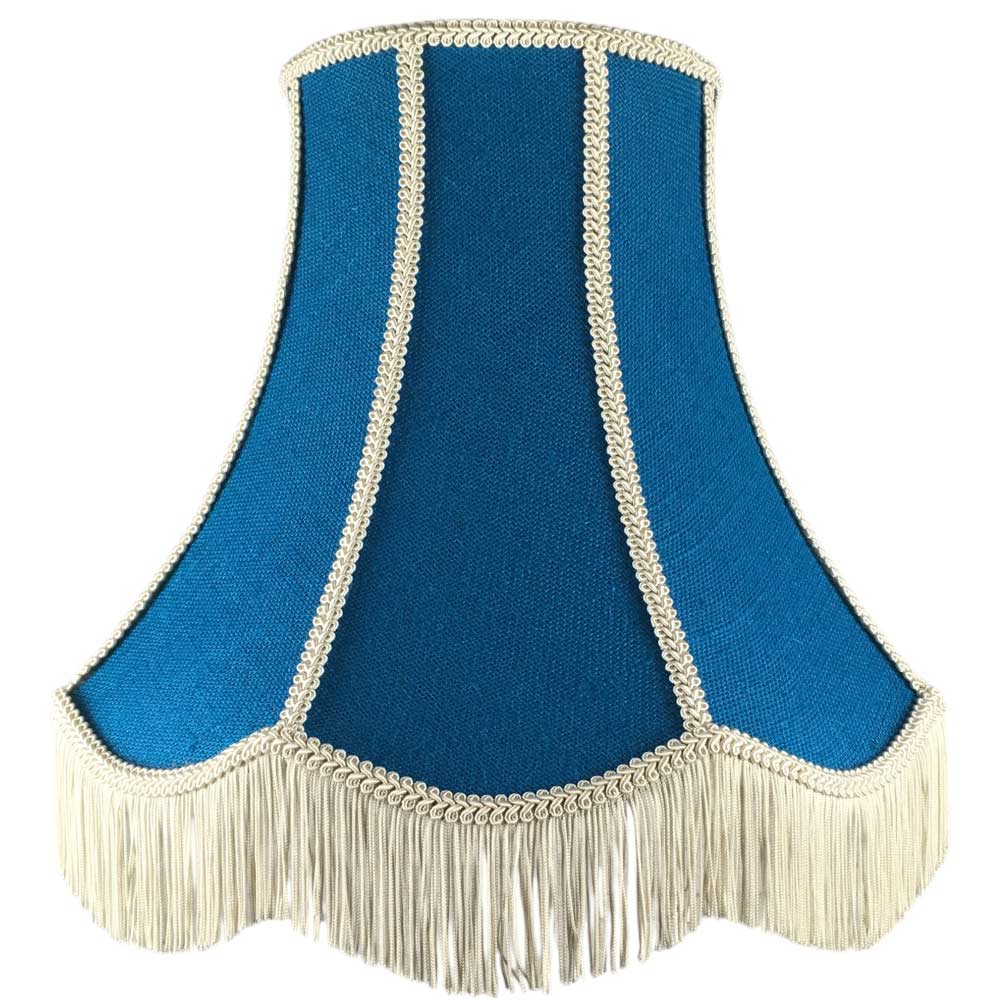 Illuminated blue hessian scalloped bowed empire lampshade with dark cream trim, cream fringe and cream balloon lining