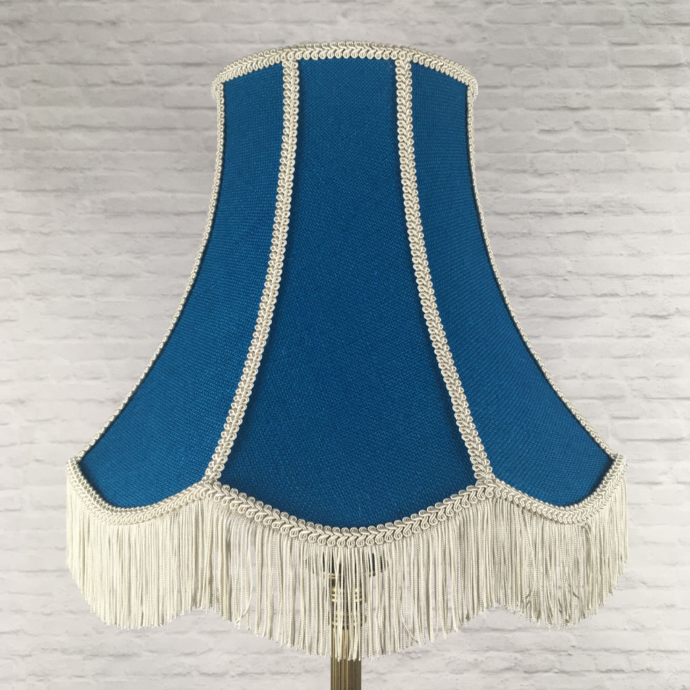 Blue hessian scalloped bowed empire lampshade with pink trim and pink fringe on floor lamp