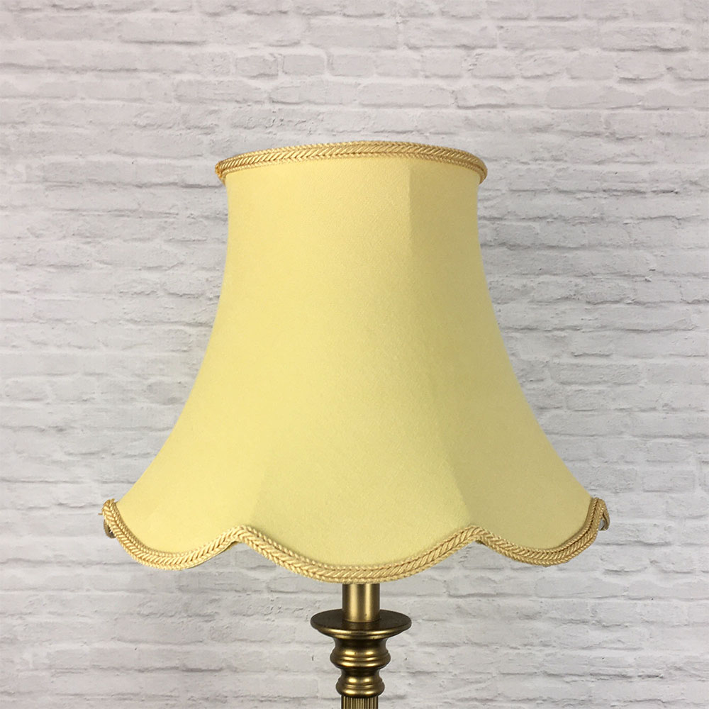Soft gold scalloped bowed empire lampshade on antique brass standing lamp