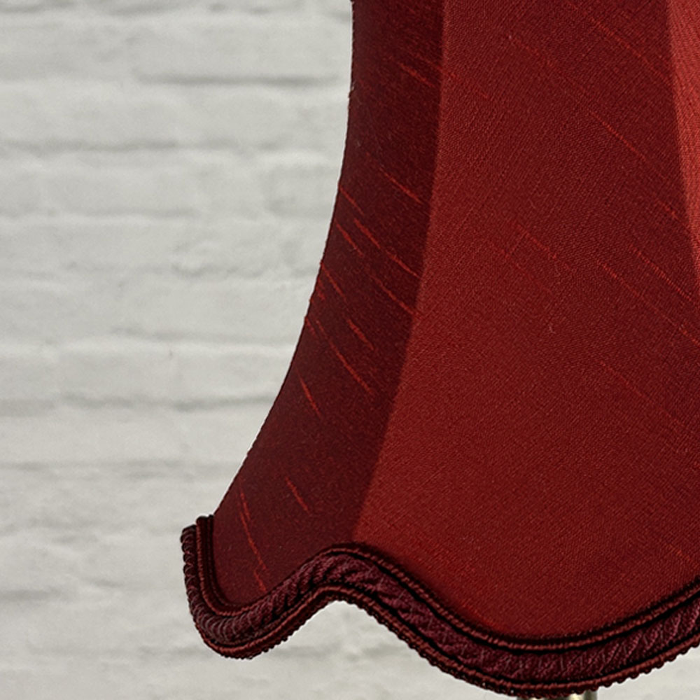 Close-up of burgundy faux silk scalloped chandelier shade with rope trim