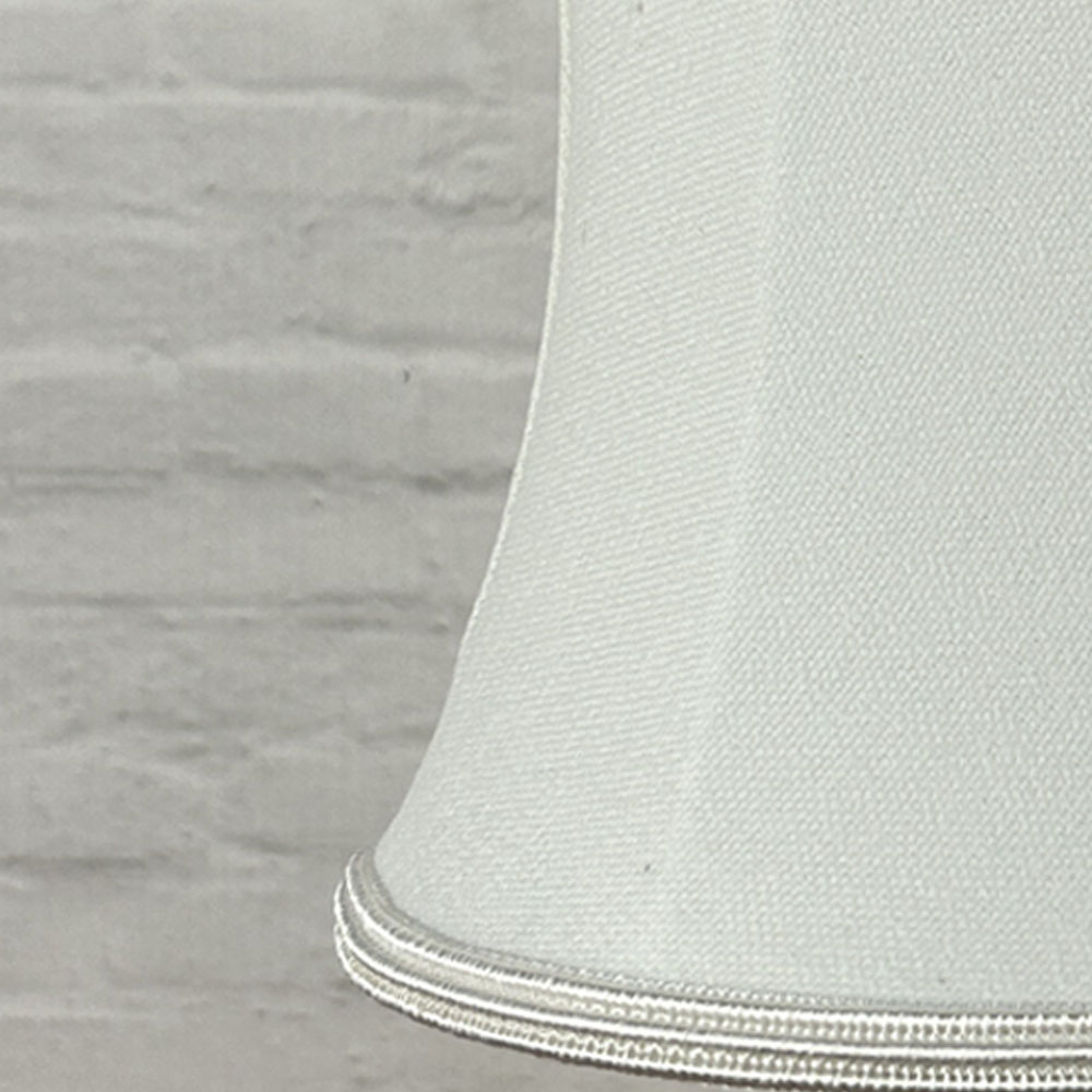 Close-up detail of a white brushed cotton bowed chandelier shade with matching soutache trim.