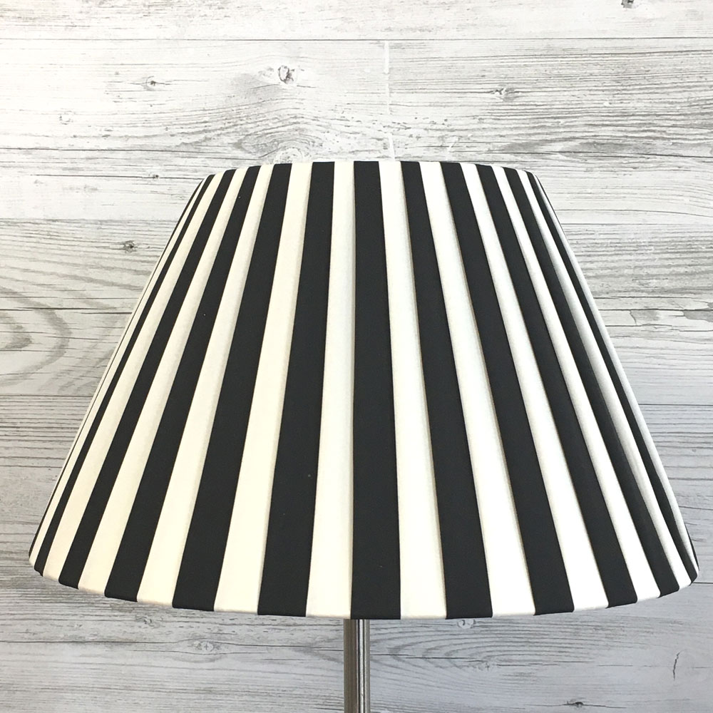 A cream and black striped pleated lampshade