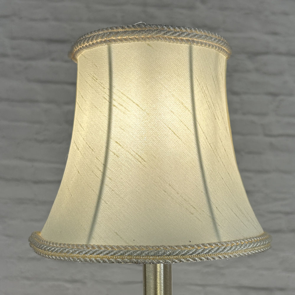 Cream bowed chandelier shade in faux silk lit showing warm glow and rope trim
