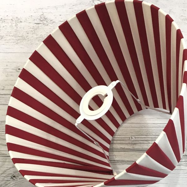 Pleated Lightshade shown on its side in burgundy and cream stripe