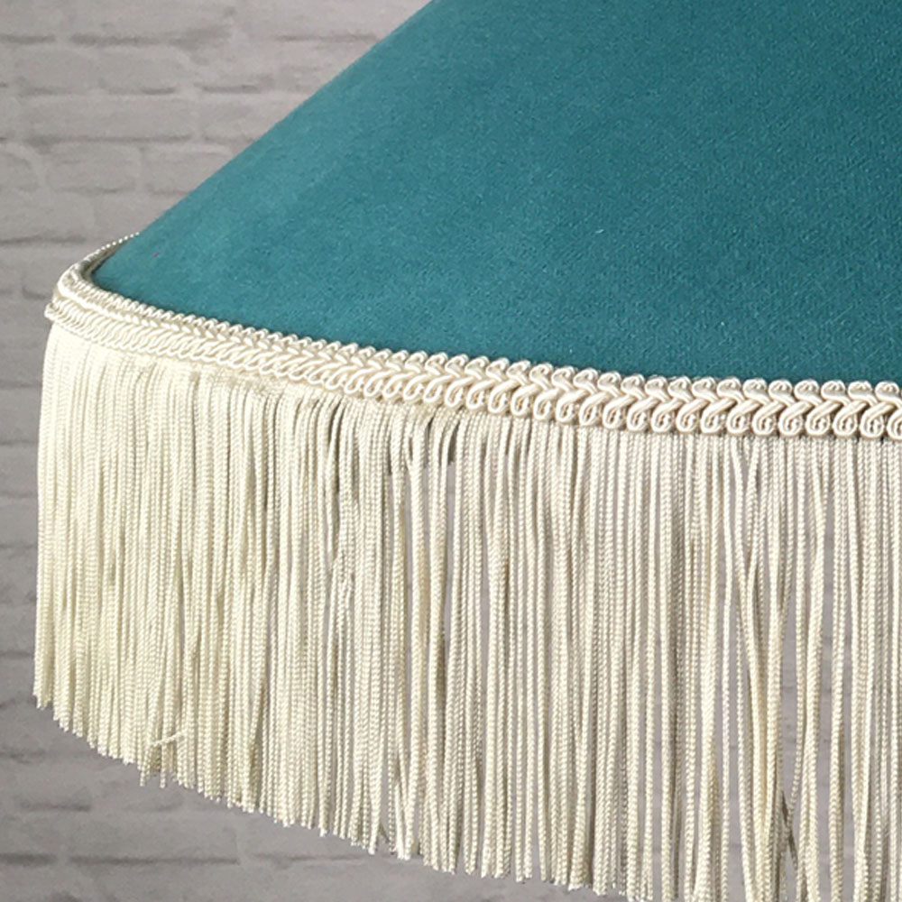 Close-up of the dark cream fringe and feather trim on the Teal & Oyster fringe lampshade.