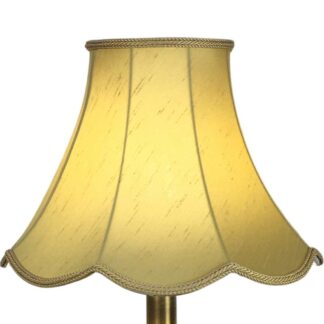 Old Gold Scalloped Faux Silk Lampshade on a Table lamp lit up