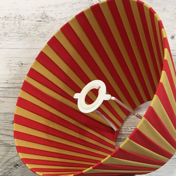 Pleated Lightshade shown on its side in Red and Gold stripe