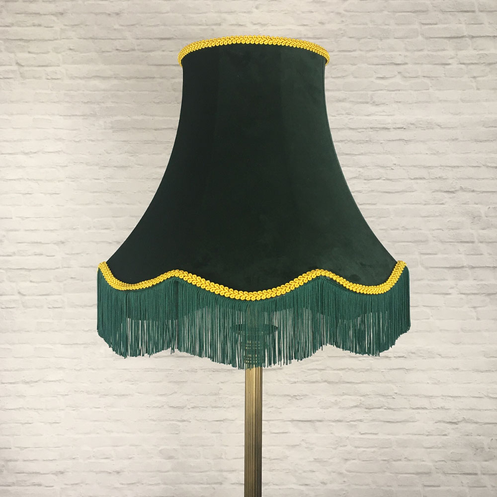 Dark green velvet scalloped bowed empire lampshade with yellow feather trim and green fringe on table lamp