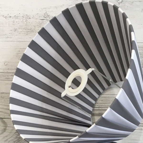 Pleated Lightshade shown on its side in grey and white stripe