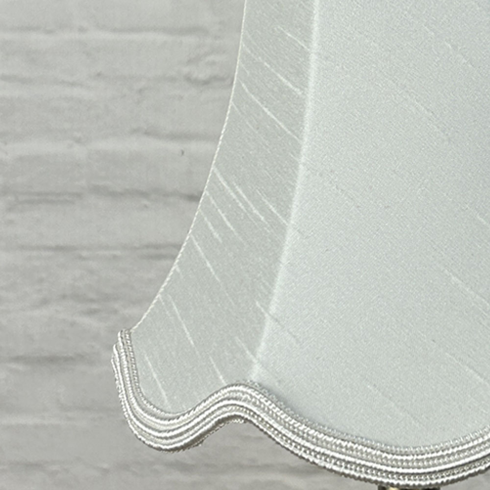 Close-up of natural faux silk scalloped chandelier shade with matching natural soutache trim