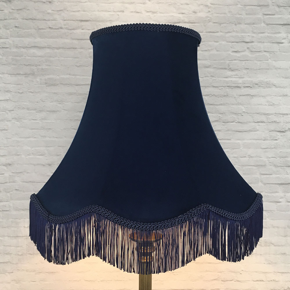 Illuminated navy velvet scalloped bowed empire lampshade with navy feather trim on floor lamp