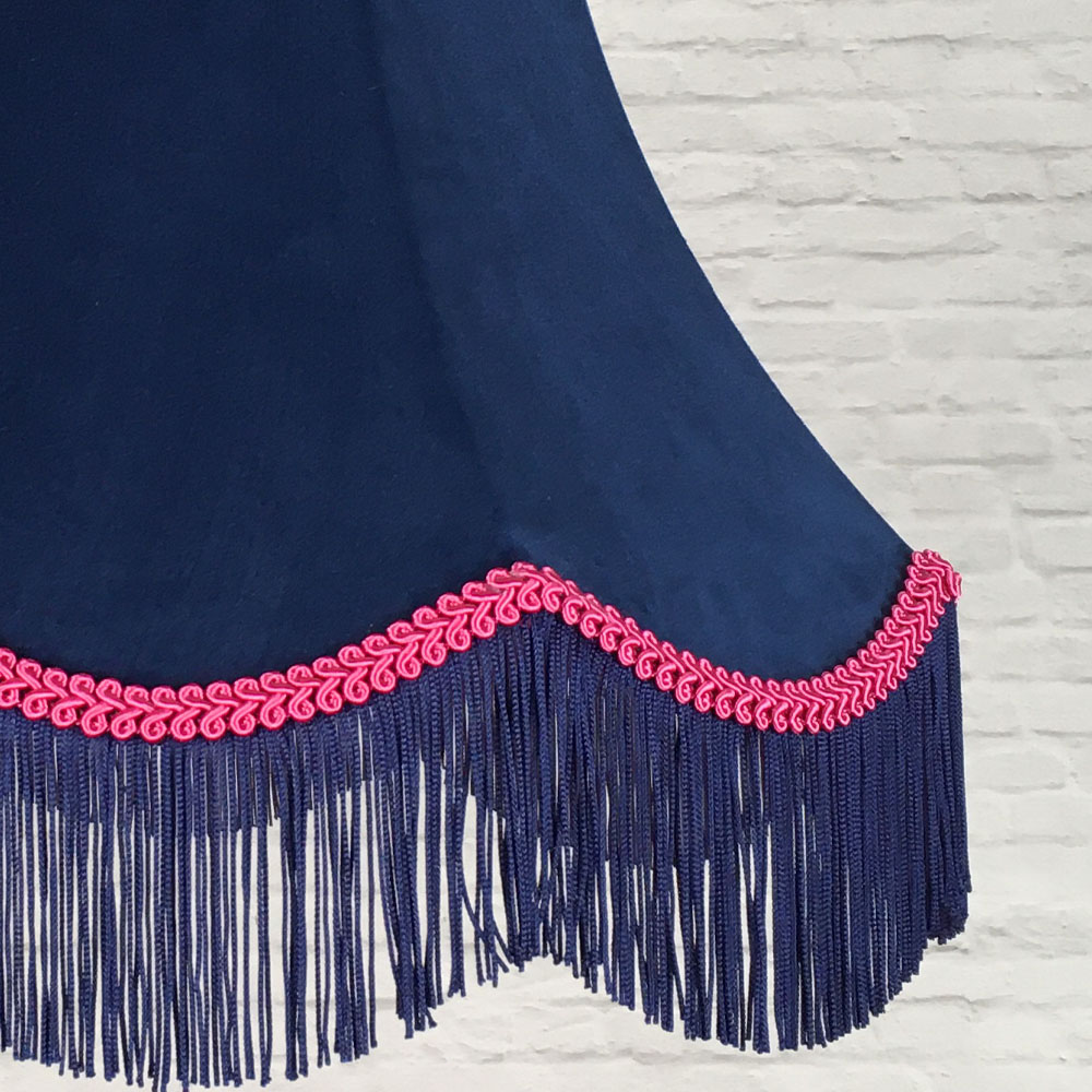 Close-up of navy velvet lampshade fabric with hot pink feather trim