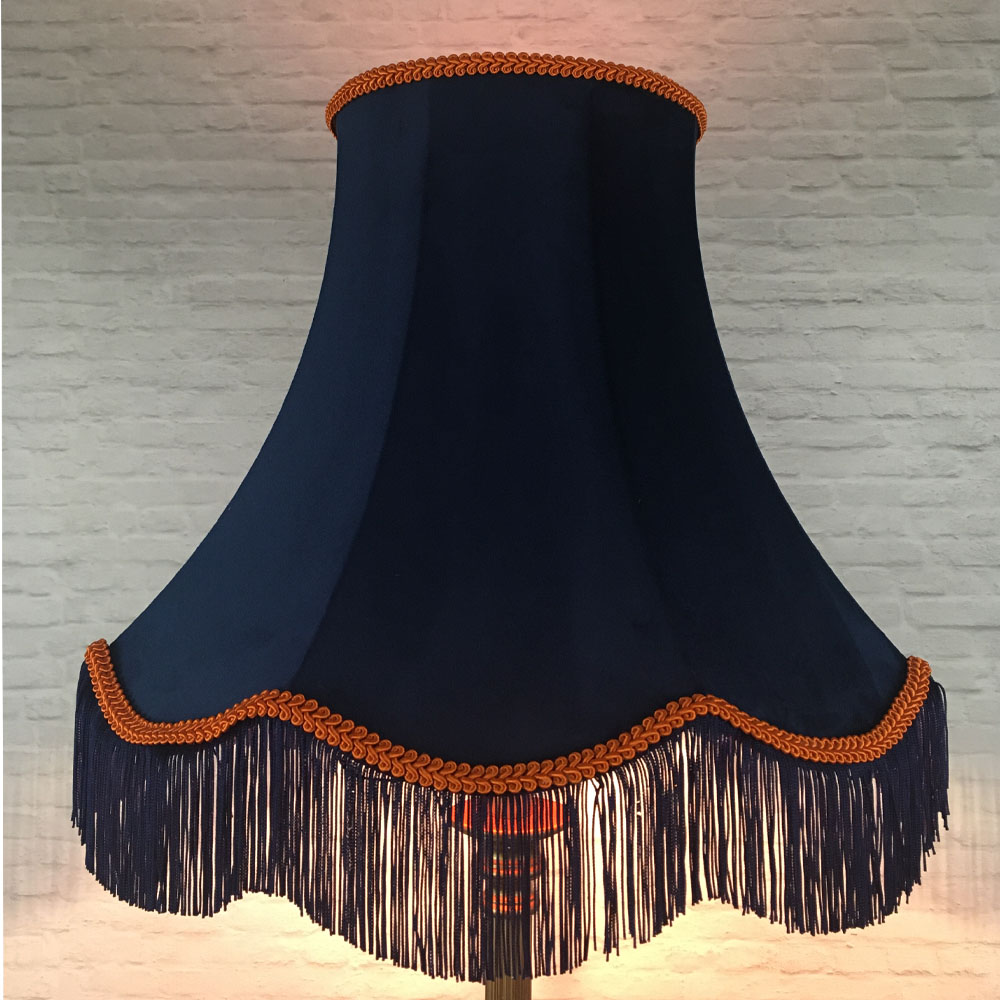 Navy velvet scalloped bowed empire lampshade with orange feather trim and navy fringe on floor lamp
