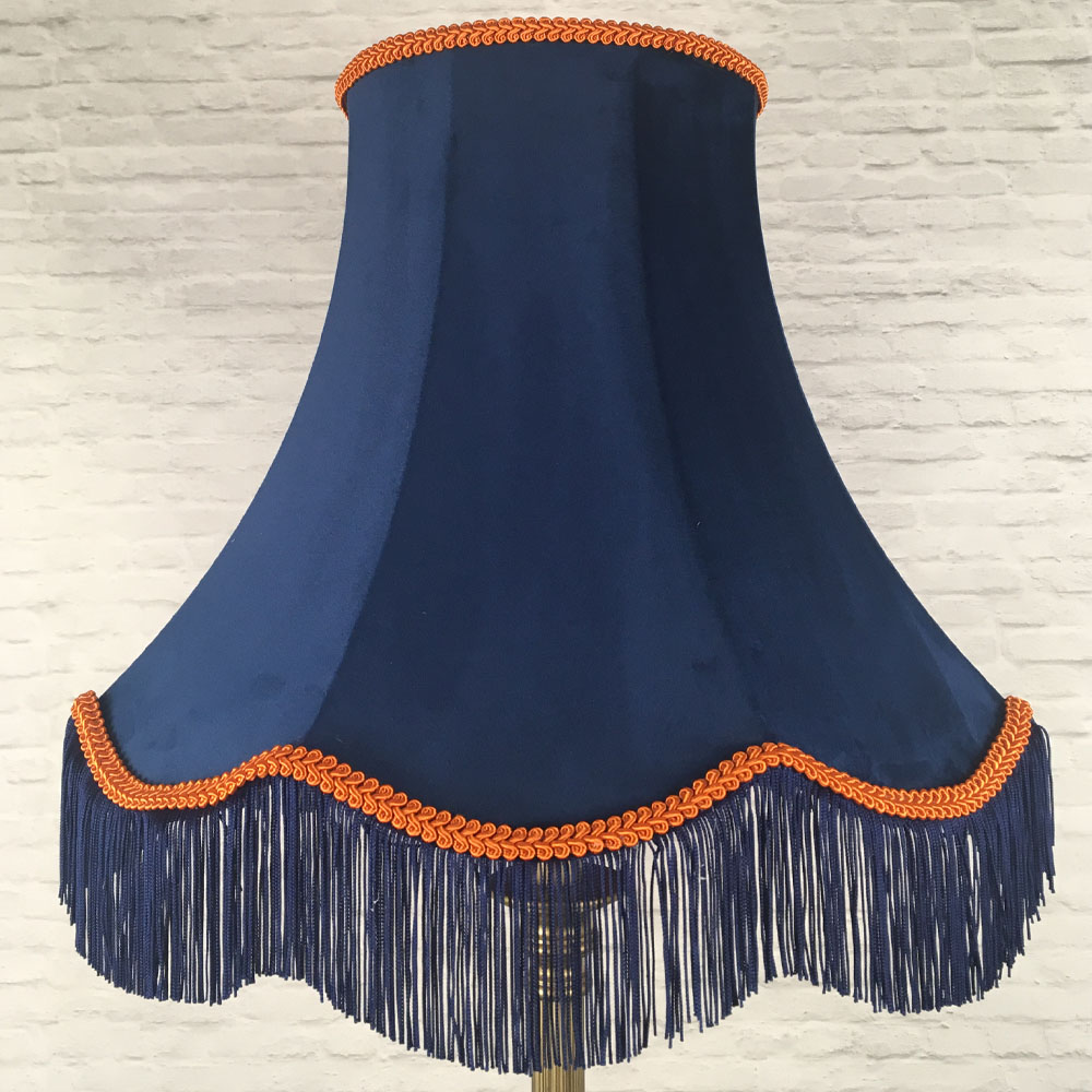 Navy velvet scalloped bowed empire lampshade with orange feather trim and navy fringe on floor lamp