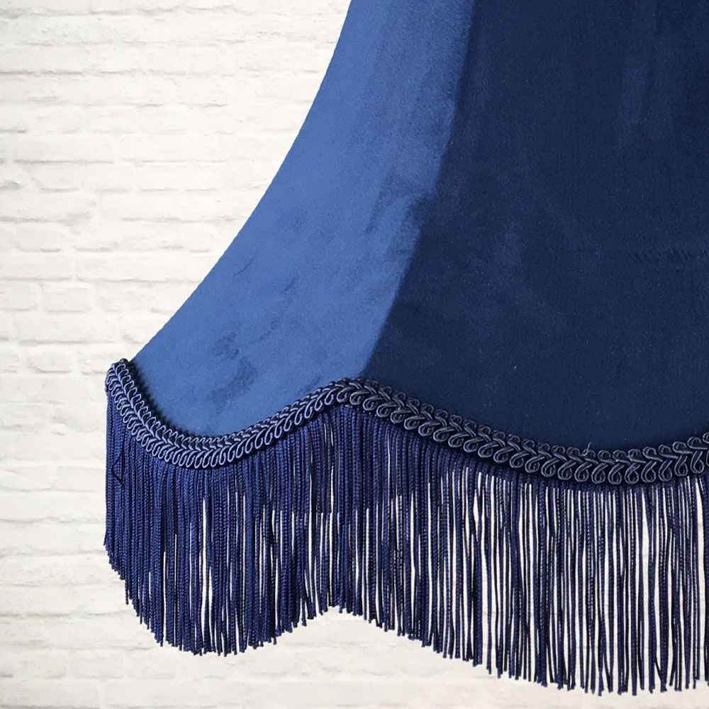 Close-up of navy velvet lampshade fabric with navy feather trim