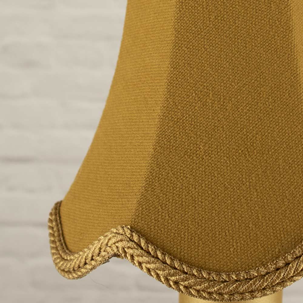 Close up image of the old gold scalloped bowed empire candle shade