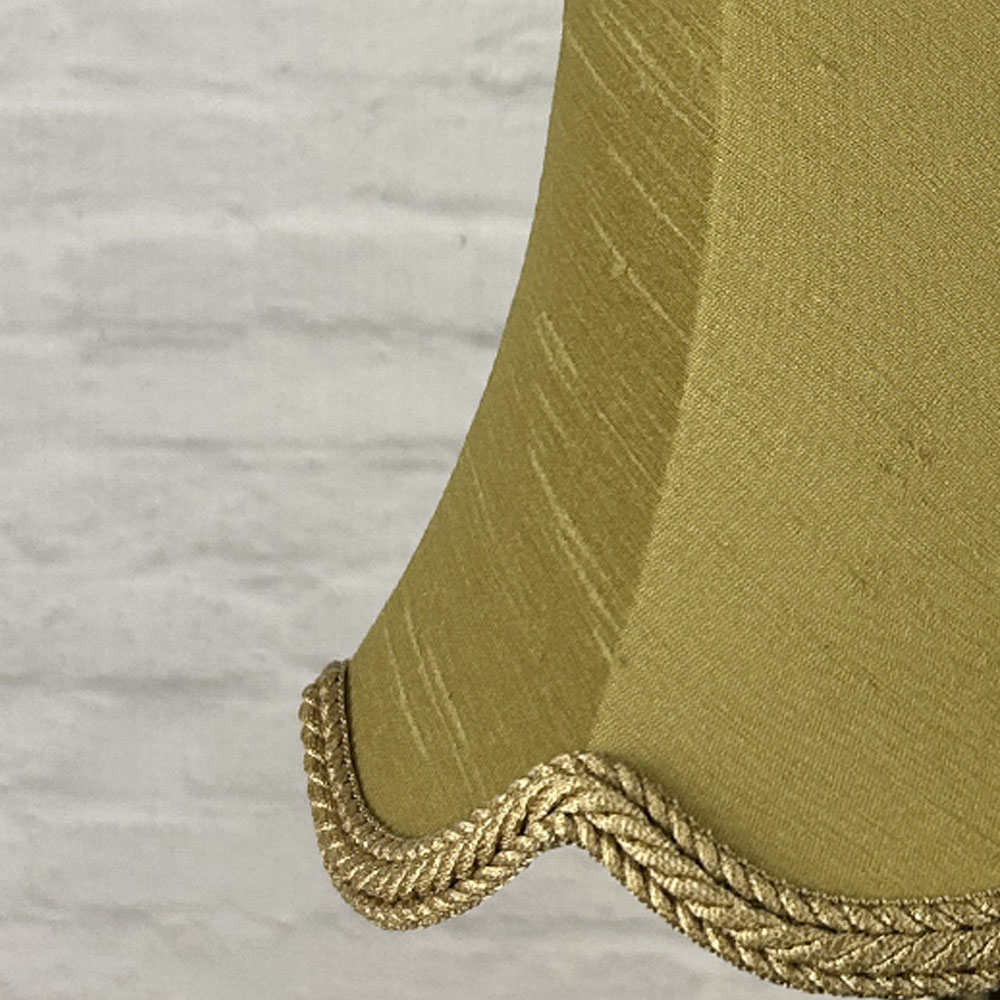 Close-up of old gold faux silk scalloped chandelier shade with rope trim