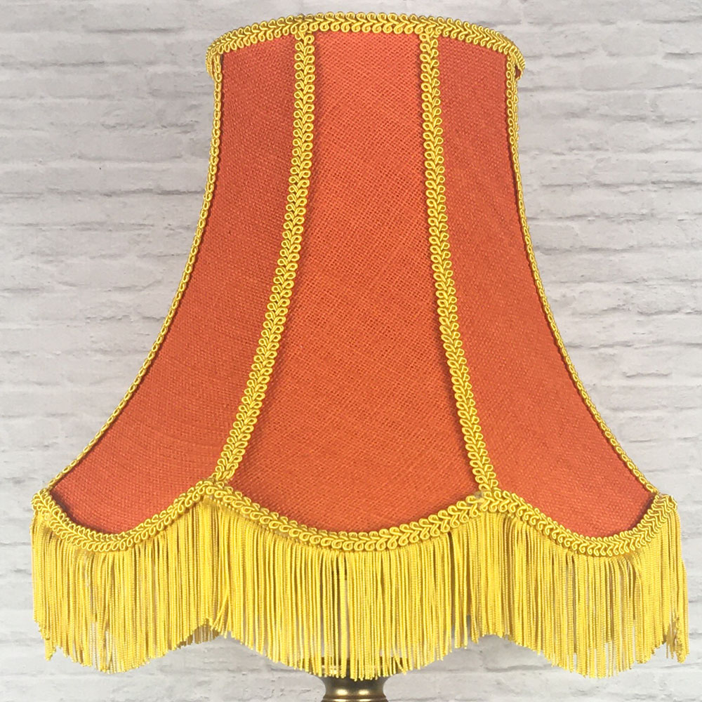 Orange hessian scalloped bowed empire lampshade with yellow trim and fringe on floor lamp
