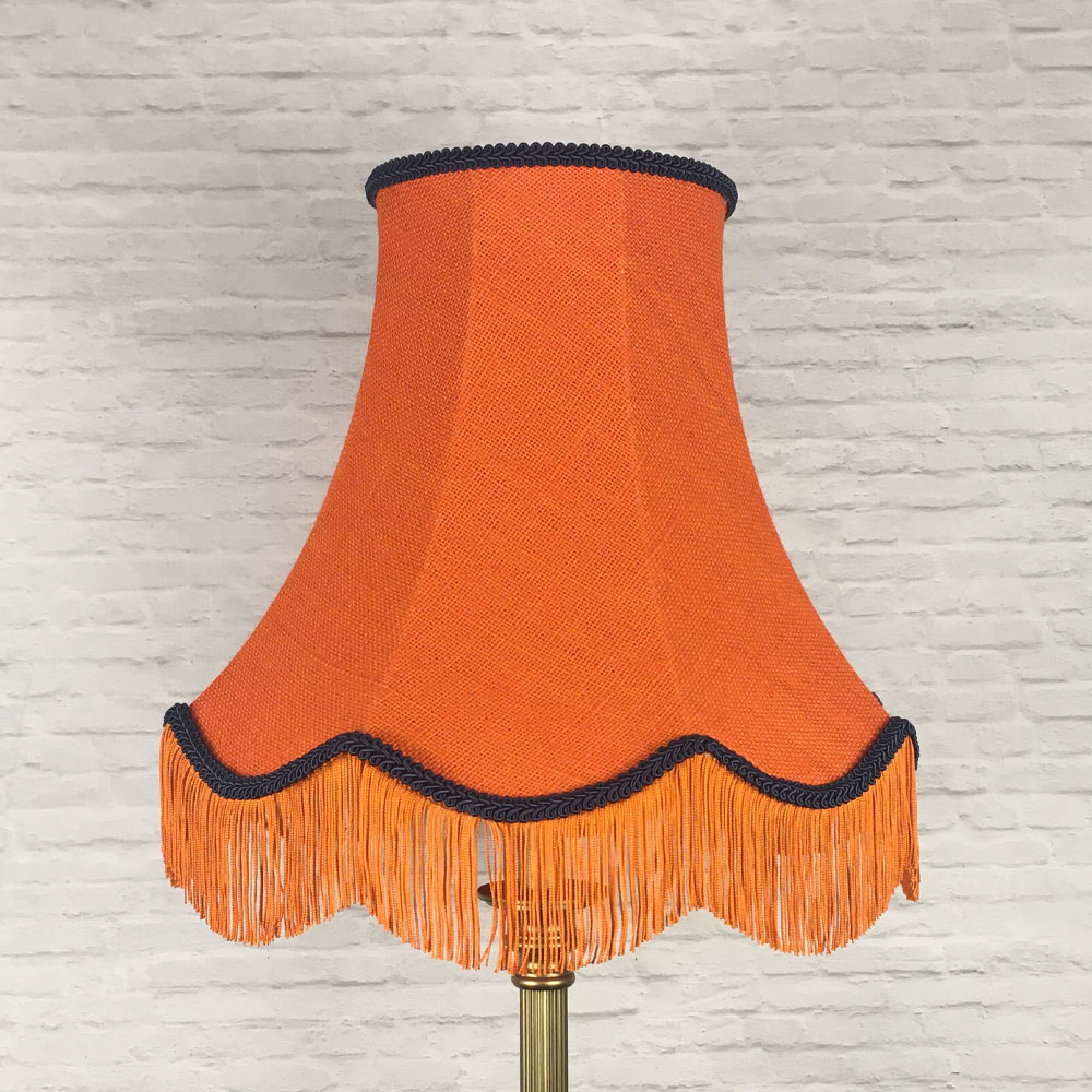Orange hessian scalloped bowed empire lampshade with navy trim and fringe on floor lamp