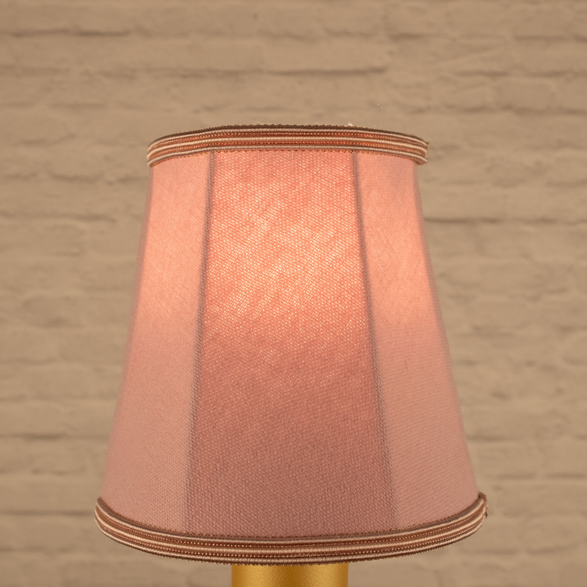 Lit pale pink empire brushed cotton candle shade with matching soutache trim