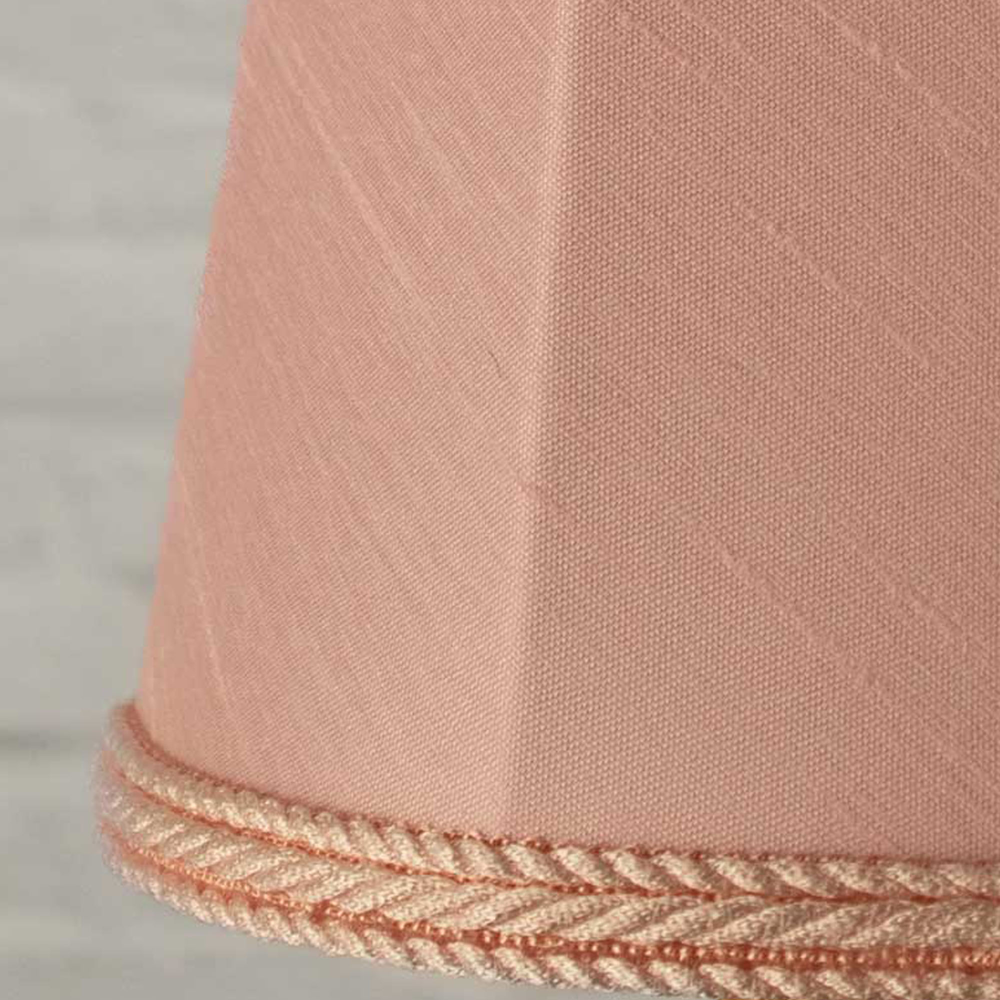 Close-up of pale pink faux silk fabric showing dupion slub texture on empire chandelier shade