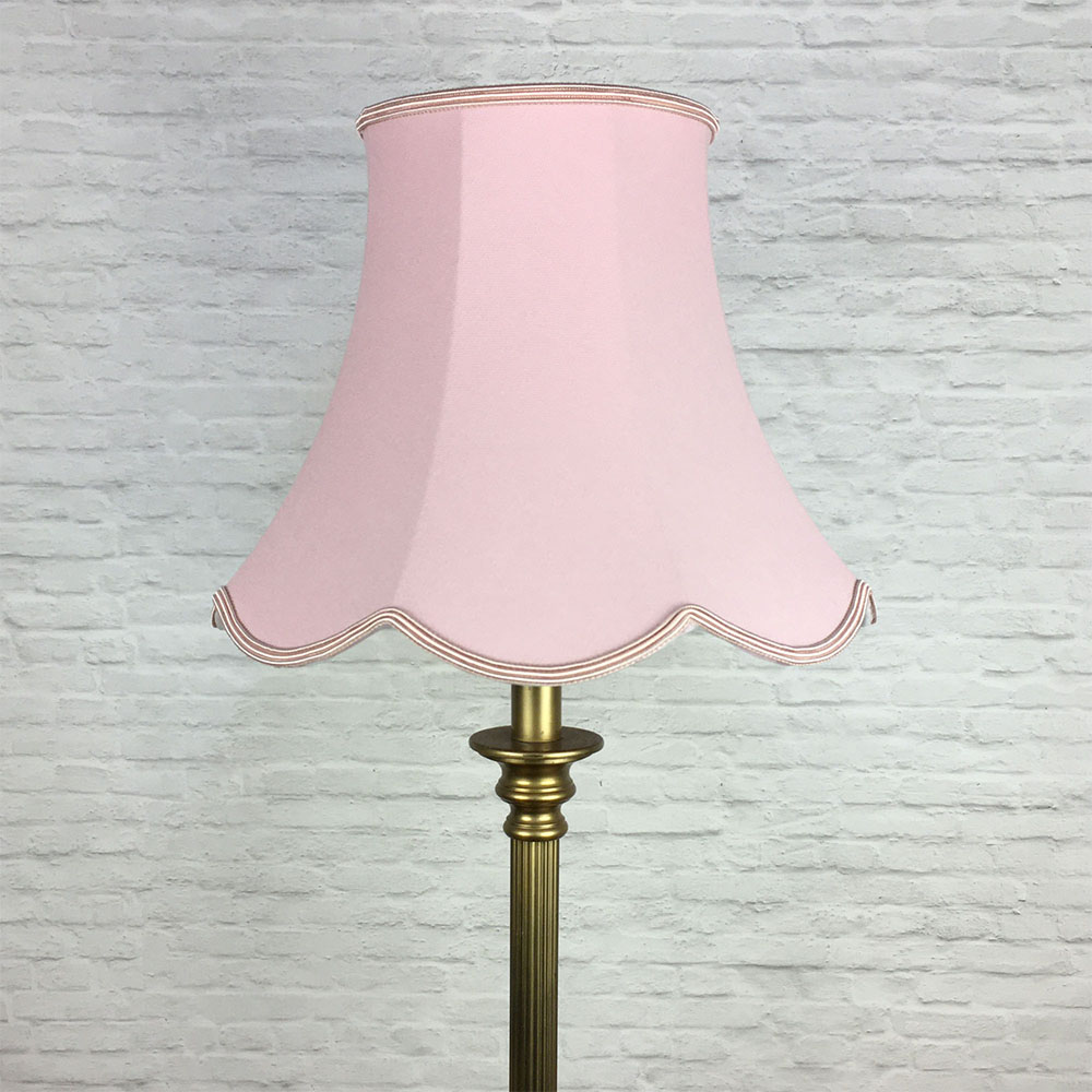 Pale pink scalloped bowed empire lampshade on antique brass standing lamp