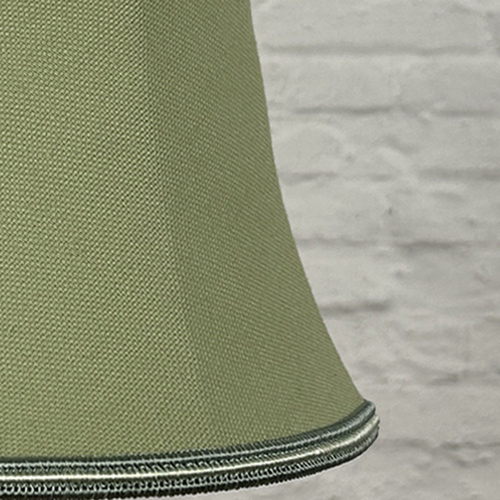Close-up detail of a pear brushed cotton bowed chandelier shade finished with contrasting green and oyster soutache trim.