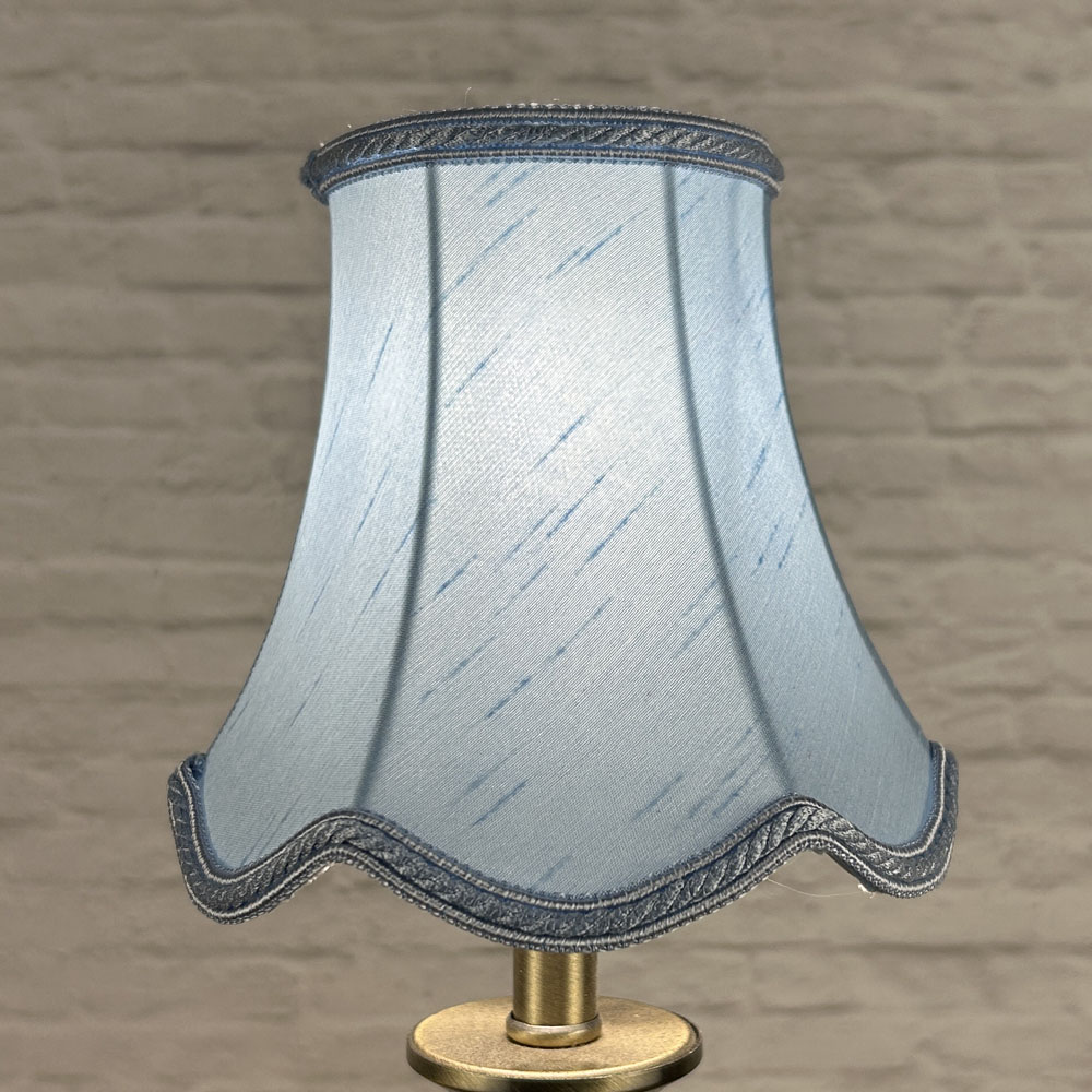 Pale blue scalloped chandelier shade in faux silk lit showing soft tone and rope trim