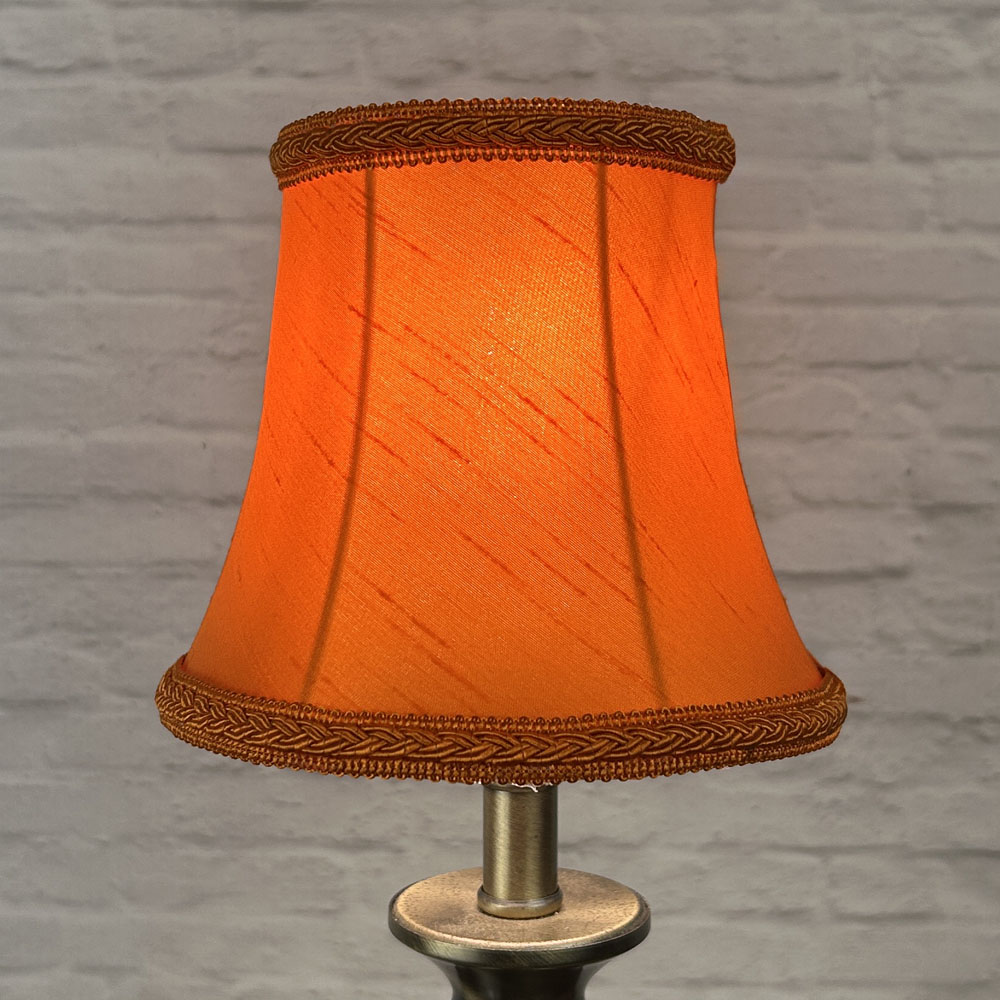 Pumpkin bowed chandelier shade in faux silk lit showing warm orange tone