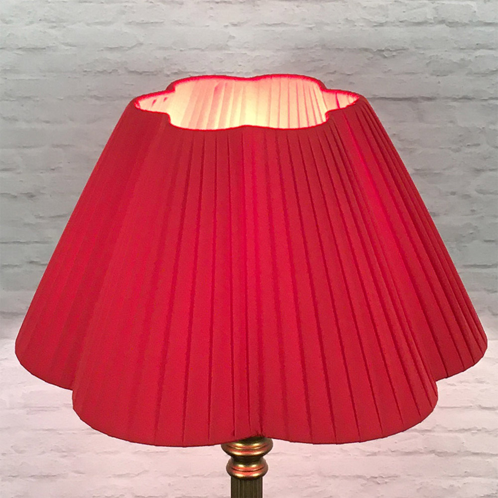 Red daisy scallop pleated lampshade on floor lamp, lit