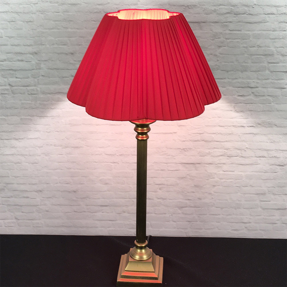 Red daisy scallop pleated lampshade on table lamp, lit