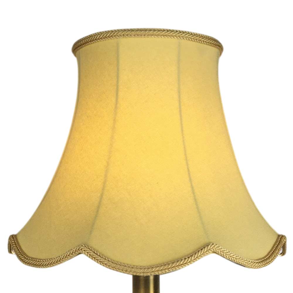Illuminated soft gold scalloped bowed empire lampshade with decorative scalloped edge