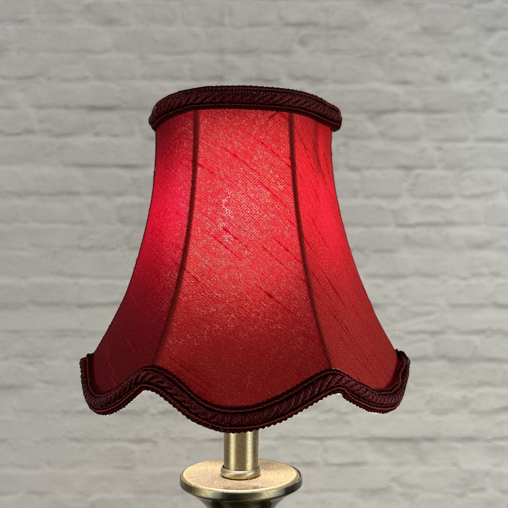 Burgundy scalloped chandelier shade in faux silk lit showing deep colour and rope trim