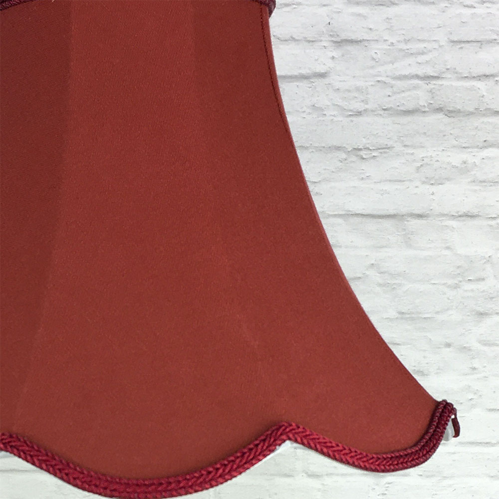Close-up of ruby scalloped bowed empire lampshade showing fabric texture and scalloped edge detail