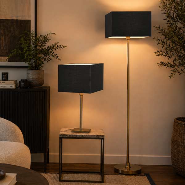 Black square lampshades on table and floor lamps in a modern living room
